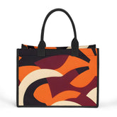 Elevate your style with this striking canvas tote bag featuring a bold, modern abstract design. The vibrant palette of orange, burgundy, black, and cream swirls across the bag in dynamic, curved shapes, creating a visually captivating and artistic statement piece. With its sturdy black handles and sleek rectangular silhouette, this bag perfectly balances form and function. Make a confident, fashion-forward impression while carrying all your essentials in this eye-catching accessory